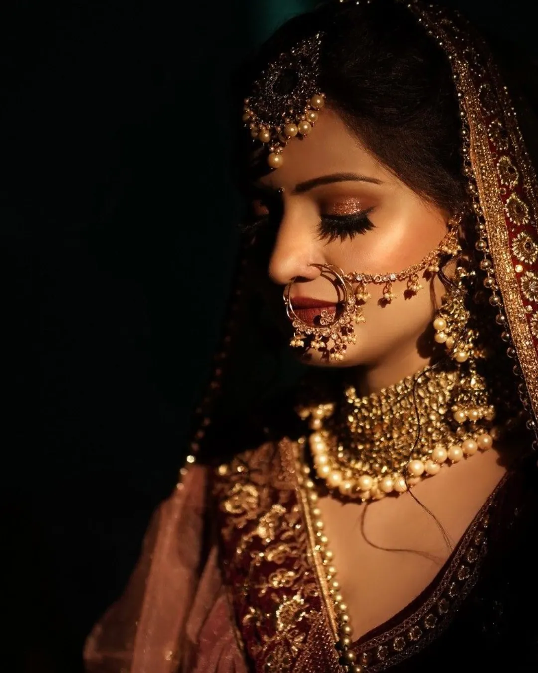 Beautiful Indian bride getting ready by the best makeup artist in Varanasi for her big day.